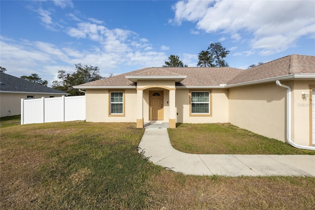 ranch-style house featuring a front lawn