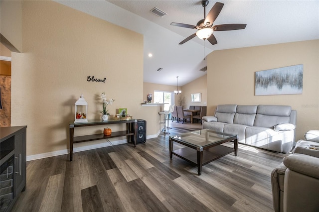 living room featuring hardwood / wood-style flooring, ceiling fan with notable chandelier, and vaulted ceiling