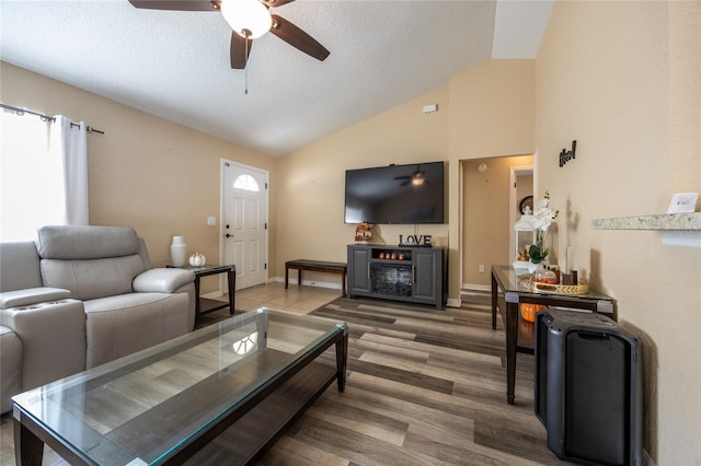 living room featuring wood-type flooring, a wealth of natural light, and vaulted ceiling