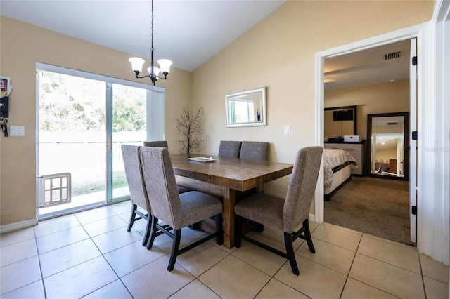 carpeted dining area featuring lofted ceiling and an inviting chandelier