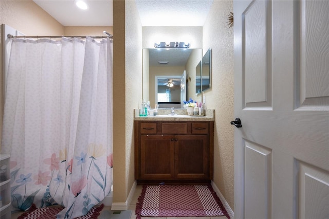 bathroom featuring a shower with curtain, vanity, and ceiling fan