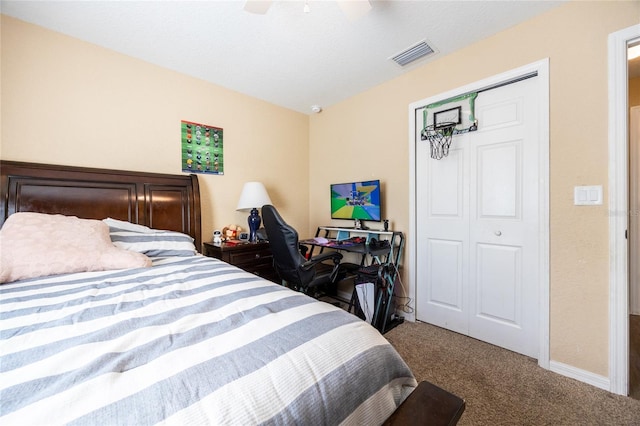 bedroom featuring ceiling fan, a closet, and carpet