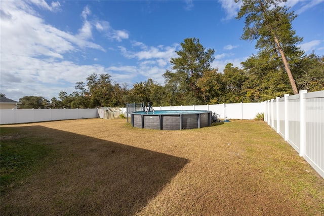 view of yard featuring a fenced in pool