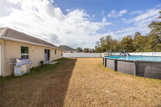 view of yard with a fenced in pool