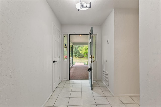 entryway with light tile patterned floors