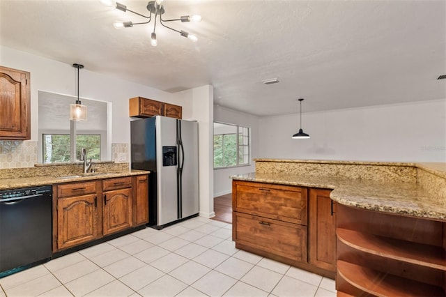 kitchen featuring plenty of natural light, sink, stainless steel refrigerator with ice dispenser, and black dishwasher