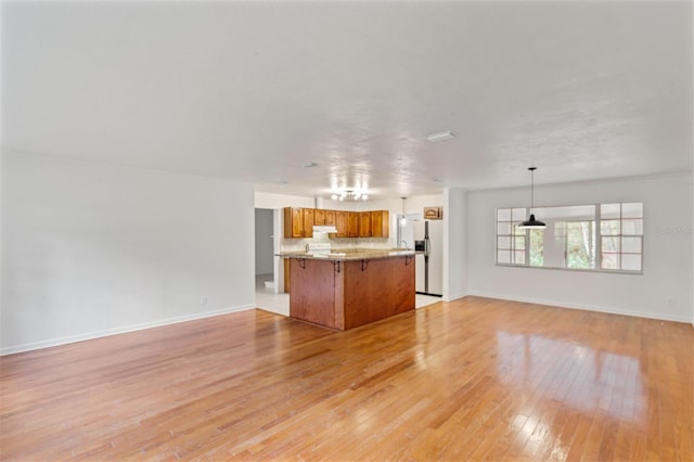 unfurnished living room featuring light wood-type flooring