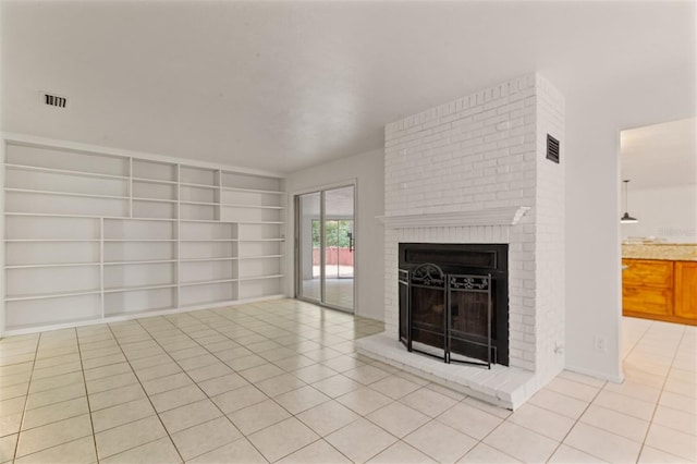 unfurnished living room featuring built in features, light tile patterned floors, and a fireplace