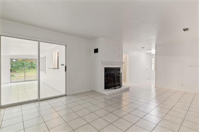 unfurnished living room featuring a fireplace and light tile patterned flooring