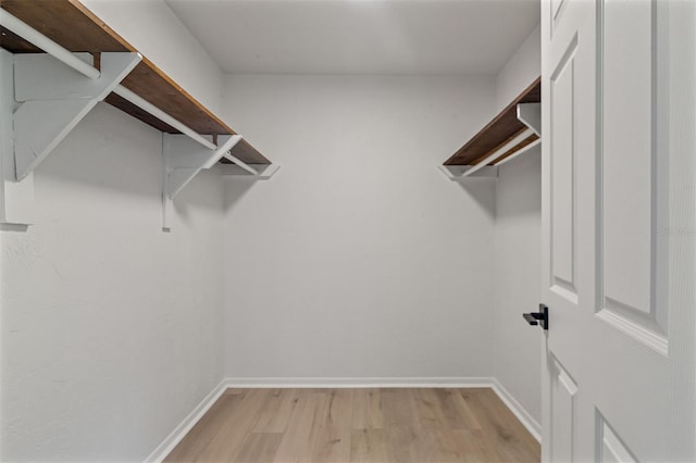 walk in closet featuring light hardwood / wood-style flooring