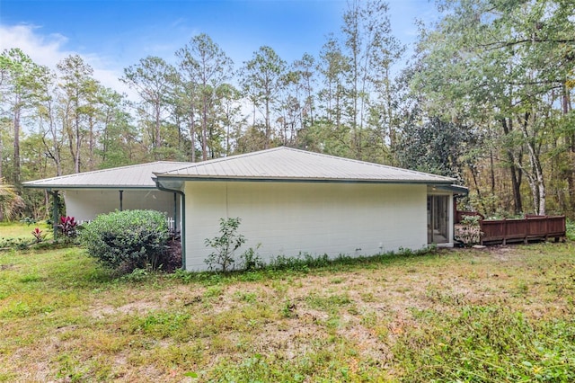 view of side of property with a yard