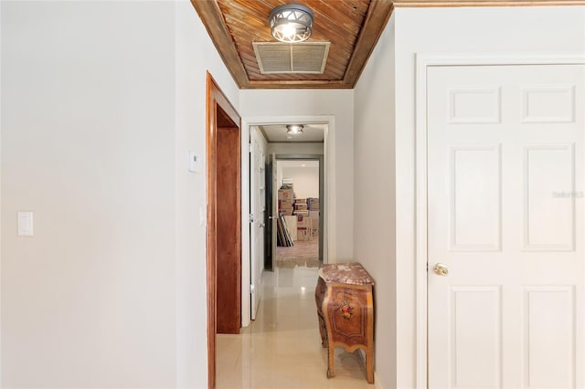 hall featuring light tile patterned flooring and wood ceiling