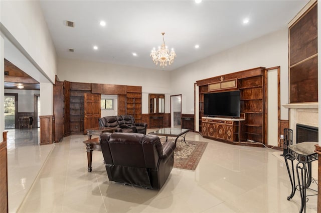 tiled living room with a notable chandelier