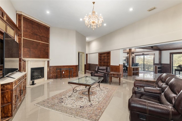 tiled living room with a fireplace and a notable chandelier