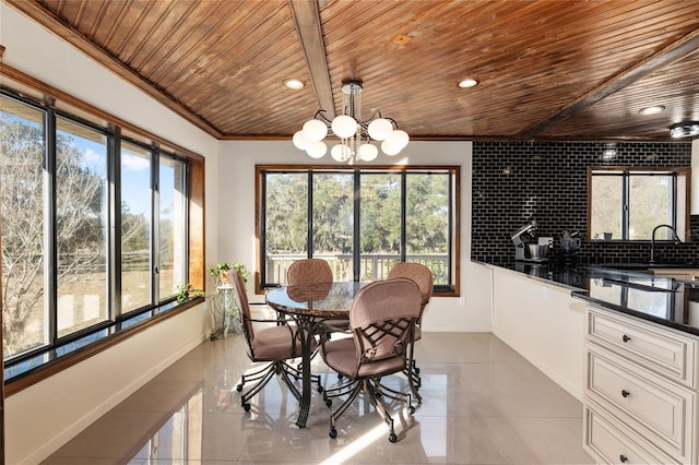 tiled dining area featuring crown molding, wooden ceiling, and a chandelier