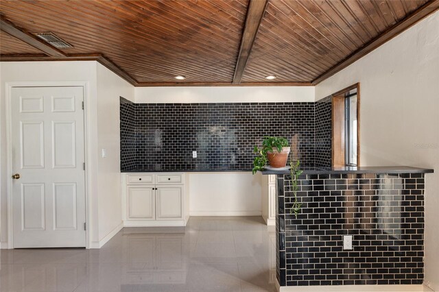 interior space featuring ornamental molding, tasteful backsplash, white cabinetry, and wood ceiling