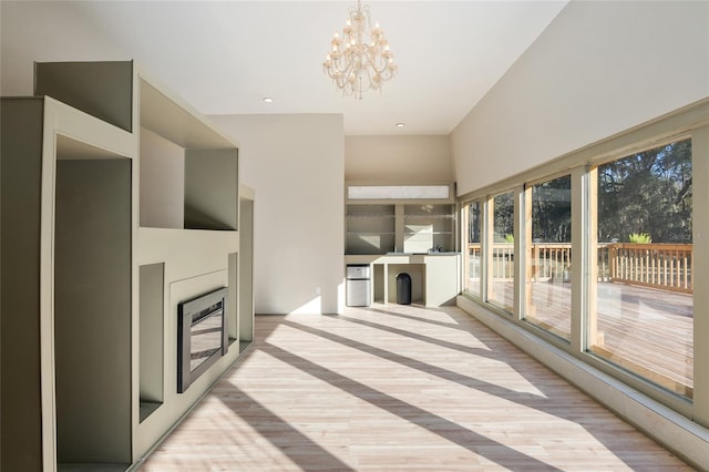 unfurnished sunroom with an inviting chandelier