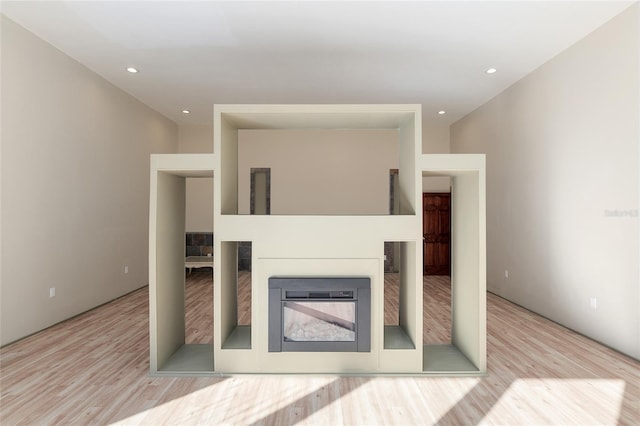 living room with light hardwood / wood-style floors and a fireplace