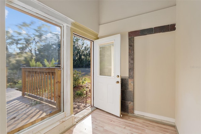 doorway to outside with light wood-type flooring