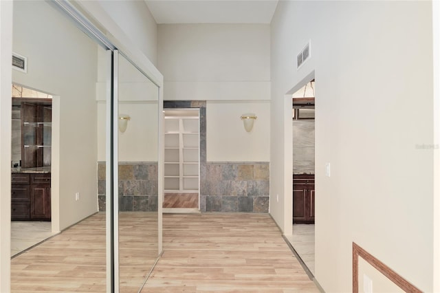 hallway with light hardwood / wood-style floors