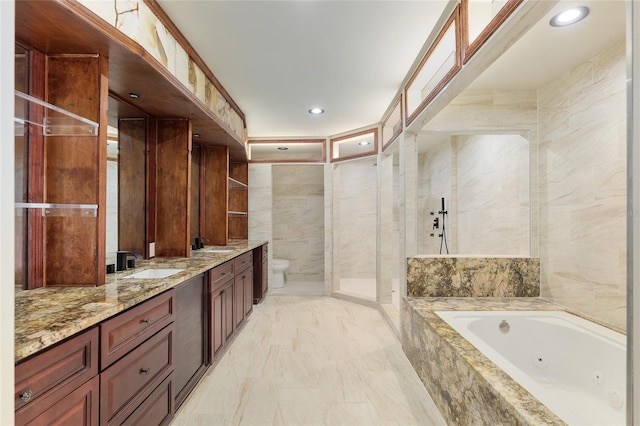 bathroom with tile walls, vanity, and shower with separate bathtub