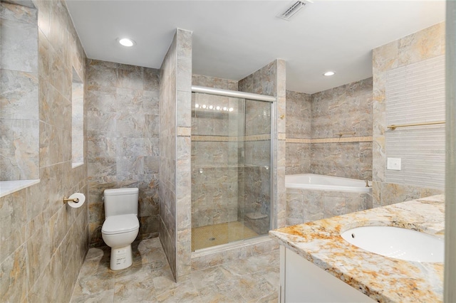 full bathroom featuring plus walk in shower, toilet, vanity, and tile walls