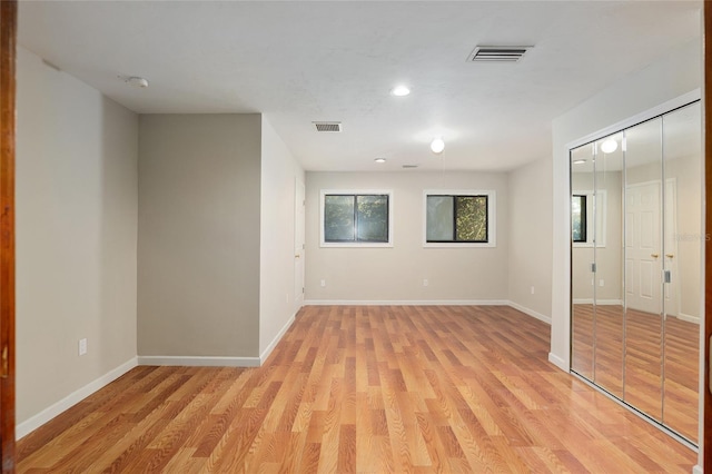 unfurnished room with light wood-type flooring