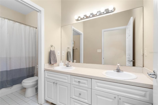 bathroom with tile patterned flooring, vanity, and toilet