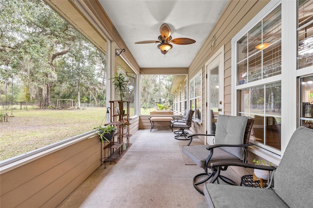 sunroom featuring ceiling fan