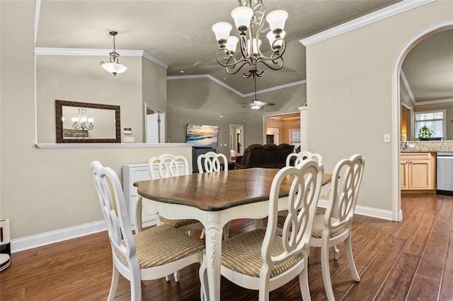 dining room with ceiling fan with notable chandelier, ornamental molding, dark wood-type flooring, and vaulted ceiling