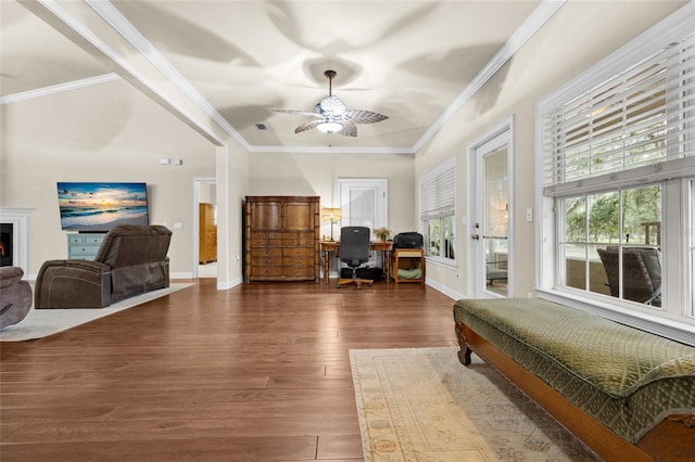 sitting room featuring hardwood / wood-style flooring, ceiling fan, and crown molding