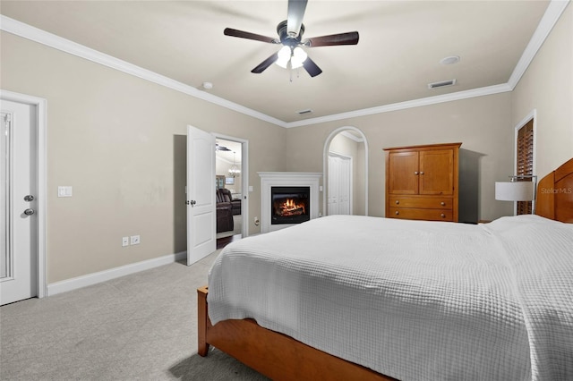 carpeted bedroom featuring ceiling fan and ornamental molding