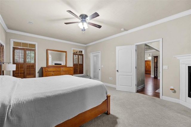 carpeted bedroom featuring ceiling fan and ornamental molding