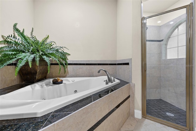 bathroom featuring tile patterned flooring and shower with separate bathtub