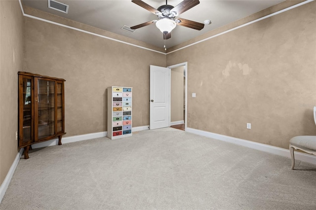 unfurnished room with light colored carpet and ceiling fan