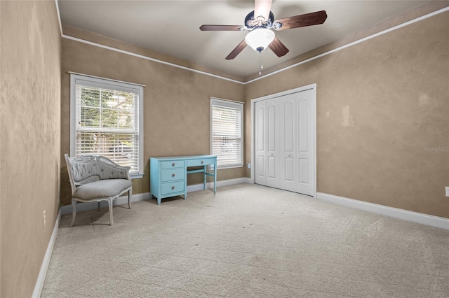 unfurnished room with ceiling fan and light carpet