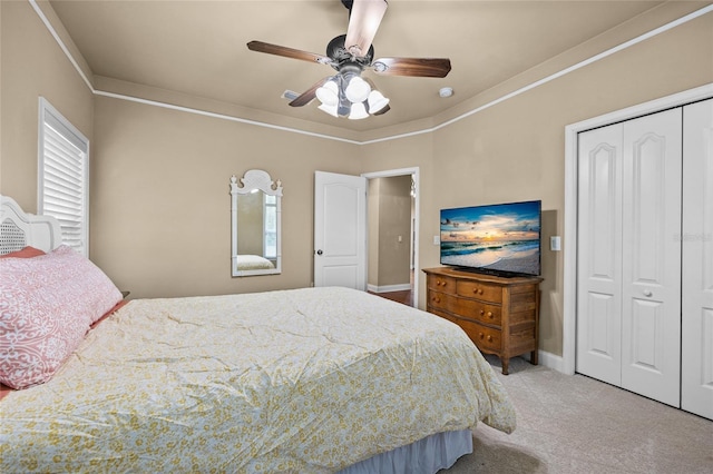 carpeted bedroom featuring ceiling fan and a closet