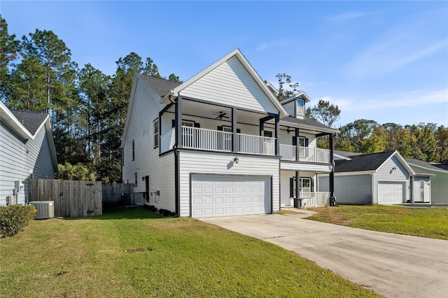 view of front of home featuring a garage, a balcony, a front yard, and cooling unit