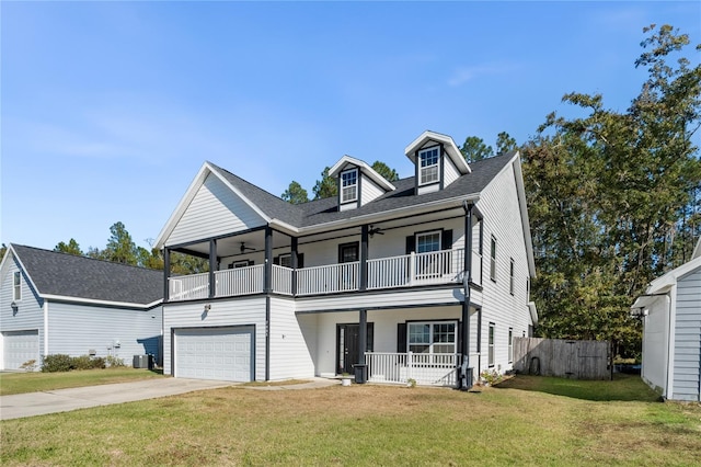 view of front of property with central air condition unit, a balcony, a front lawn, covered porch, and a garage