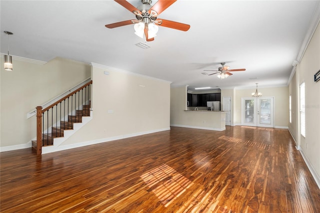 unfurnished living room featuring crown molding, french doors, dark hardwood / wood-style floors, and ceiling fan with notable chandelier