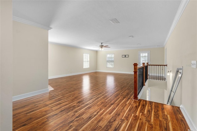 unfurnished room featuring dark wood-type flooring, ceiling fan, and ornamental molding