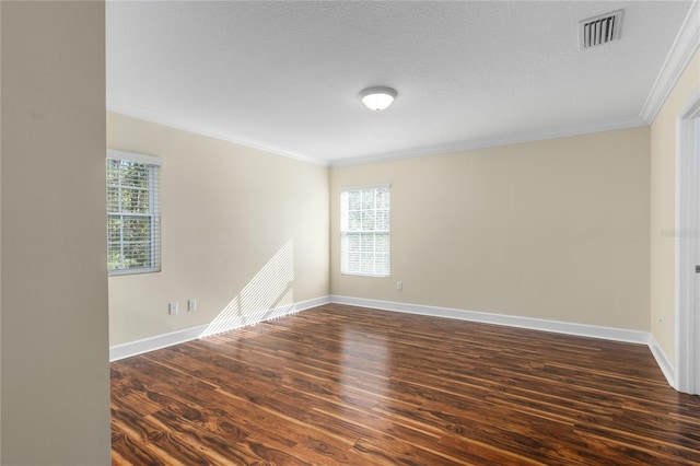 empty room with dark hardwood / wood-style flooring, ornamental molding, and a textured ceiling