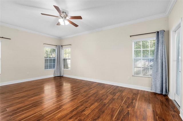 empty room featuring a wealth of natural light, crown molding, and dark hardwood / wood-style floors