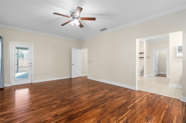 empty room featuring ceiling fan, light wood-type flooring, and ornamental molding