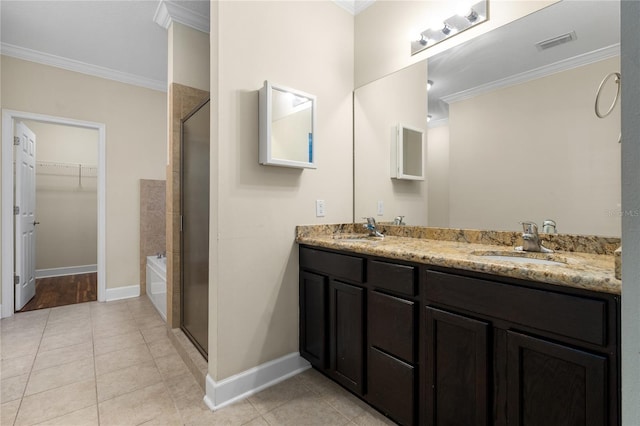 bathroom with vanity, crown molding, tile patterned flooring, and plus walk in shower