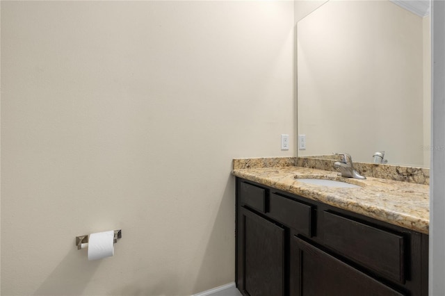 bathroom with vanity and ornamental molding