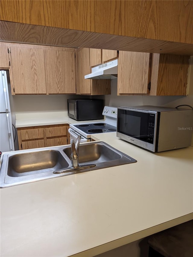 kitchen featuring sink and white appliances