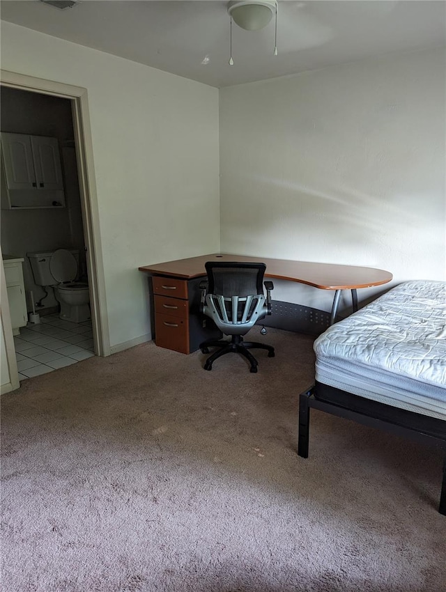 carpeted bedroom featuring ensuite bath and ceiling fan