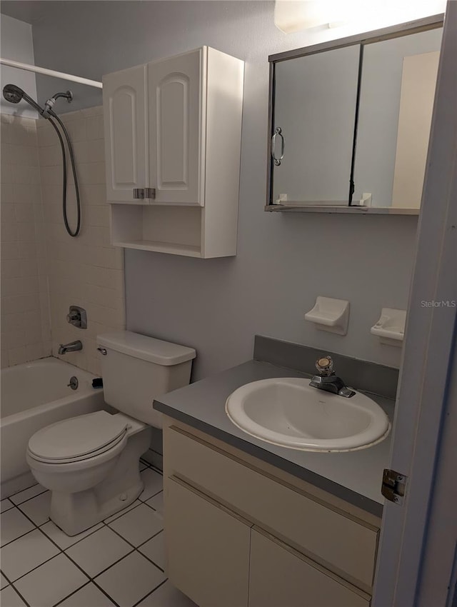 full bathroom with vanity, tiled shower / bath combo, toilet, and tile patterned flooring