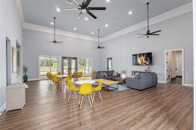 living room featuring hardwood / wood-style floors and a towering ceiling